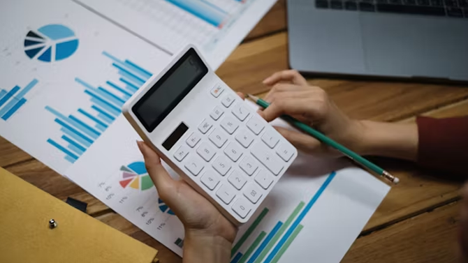 Business owner managing digital marketing budget on laptop
